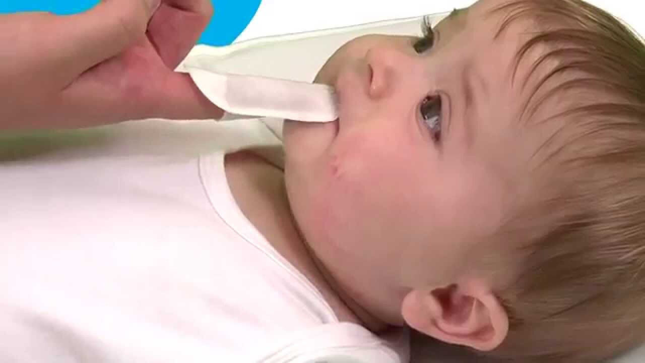 Từ 0 – 12 tháng, giữ vệ sinh răng miệng cho trẻ bằng cách lau nhẹ nướu bằng khăn sạch. (nguồn: parentlane.com)