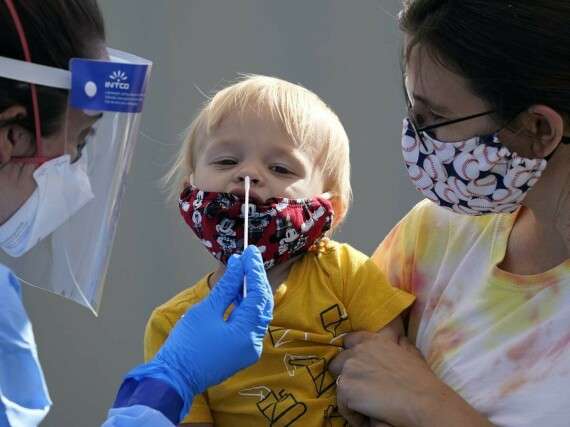Một em bé đang được lấy mẫu làm xét nghiệm SARS-CoV-2. (Nguồn: theconversation.com)